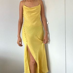 Sleek golden satin dress with button split